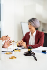 Attorney performs legal tasks to prepare cases. Lawyers at desk consulting, discussing to advise and represent client in criminal or civil proceeding, legal matter.