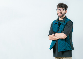 Smiling and handsome guy with glasses holding  arms crossed isolated. Portrait of cool and handsome casual man with glasses and crossed arms