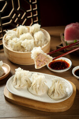 Handmade Fresh Shumai Meat Dumplings in Bamboo Steamer with Chopsticks and Dipping Sauce