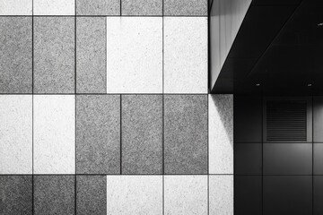 Architectural study of a building facade, with checkered paneling and sharp angles in a monochrome scene