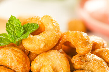 Vietnamese Salt-Baked Fried Cashew Nuts with Mint Garnish - Golden Crispy Amber Coated Snack