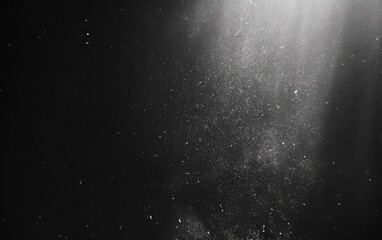 Atmospheric grayscale scene with light rays piercing down, particles floating. Dark, abstract background