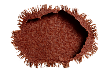 Close up of a textured circular fringed object filled with tiny brown seeds against a black background