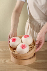 Traditional Handmade Chinese Steamed Buns with Fortune Symbols in Bamboo Steamer