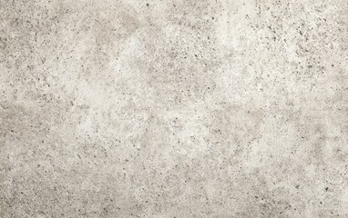 Fototapeta premium A neutral, mottled surface displays a lightly textured pattern with varying shades of gray and beige