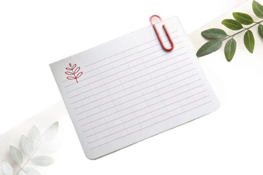 White blank rectangular note paper with a red paperclip on the corner 