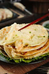 Handmade Scallion Pancakes with Chopsticks - Traditional Asian Panfried Food with Fresh Green Onions and Crispy Golden Layers