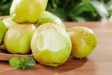Fresh Korla Balsam Pears from Xinjiang China - Whole Bitter Gourd Vegetables on Wooden Board
