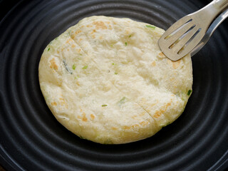Handmade Scallion Pancake Frying in Pan with Wooden Spatula - Asian Street Food Cooking