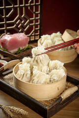 Traditional Chinese Siu Mai Dumplings in Bamboo Steamers with Chopsticks - Authentic Asian Cuisine