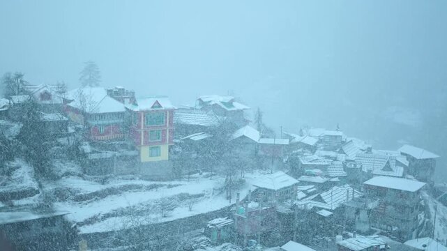 4K Slow motion shot of Sangla village covered by snow during a blizzard in winter season at Himachal Pradesh, India. Houses covered by snow during snowstorm in the winter season. Winter background.