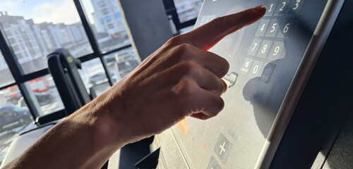 Person Pressing Button on Treadmill Control Panel in Gym