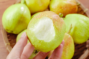 Fresh Xinjiang Fragrant Pears Hand Holding Peeled Crisp White Flesh Fruit in Wooden Basket Display