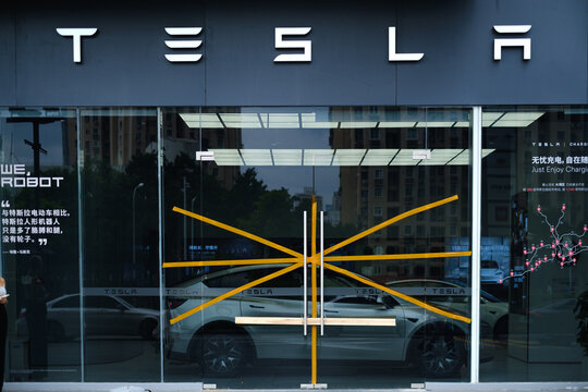 Shenzhen, China - September 4, 2025: A closed Tesla store, taped windows, and boarded-up doors. The concept of cancellation of the Tesla brand