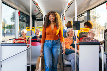 African american woman traveling on public transport, carrying shopping bags, with diverse passengers in a city setting