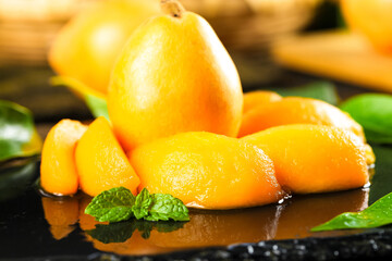 Sweet Loquat Fruit Slices from Yunnan China with Mint Garnish on Wood