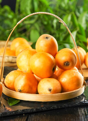 Fresh Loquat Fruits in Wicker Basket - Traditional Chinese Alpine Fruit from Yunnan Panzhihua Region