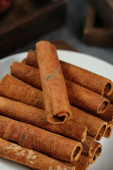 Natural Cinnamon Bark Sticks Spice Ingredient on White Plate