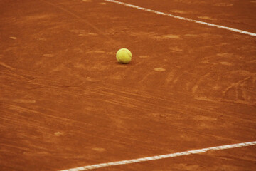 Tennis Ball on Clay Court &ndash; Focus, Stillness and Game Preparation Concept