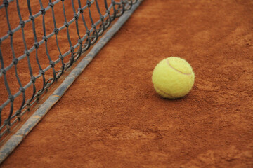 Tennis Ball Near the Net on Clay Court &ndash; Focus, Challenge and Motivation Concept
