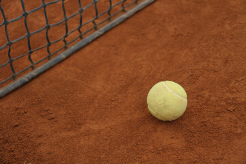Tennis Ball Near the Net on Clay Court &ndash; Focus, Challenge and Motivation Concept