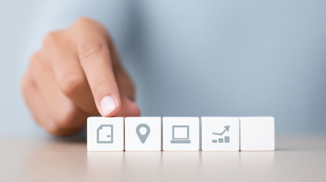 Focused hand selects technology icon block. Business strategy plan and concept for company growth, foundation for future development