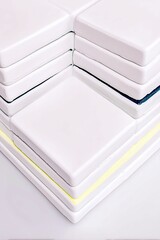 A close-up, abstract view of a stack of white, square tiles, with thin, subtle lines of dark blue and yellow visible between some of the layers.