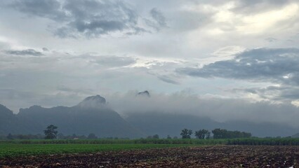 clouds over the field mountain