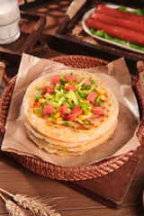 Handmade Savory Pancakes with Scallions and Vegetables in Rustic Basket - Traditional Breakfast Food