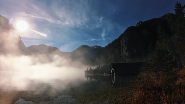 Sunrise timelapse with Lake Konigsee, in Bavaria, with dense fog on a sunny day of autumn
