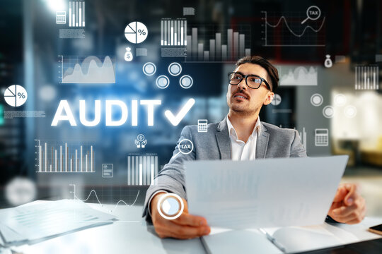 Professional man reviewing financial documents during an audit in an office environment