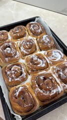 Freshly Baked Cinnamon Rolls with Icing – Close-Up of Sweet Pastry in Baking Tray