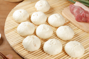 Handmade Fresh Meat Buns with Scallion on Bamboo Mat - Traditional Asian Steamed Dumplings