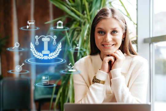 Young professional woman smiling in a modern office environment with digital icons around her