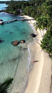 Discover the beauty of Koh Kood Island in Thailand, featuring white sandy beaches and lush palm trees. Relax as uple stroll along the shoreline, soaking in the serene atmosphere and clear waters.