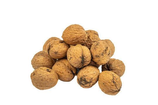 Pile of whole walnuts in shells on white background, macro close-up, natural food, healthy snack, edible product.