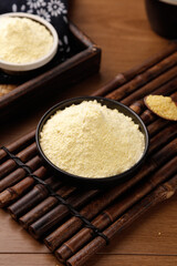 Fresh Yellow Rice Flour in Bowls on Bamboo Mat - Traditional Asian Cooking Ingredient