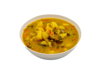 Traditional cucumber soup with potatoes and vegetables in white bowl on white background, homemade Polish cuisine dish