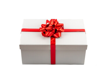 White gift box with red ribbon and bow on white background, Christmas or birthday present.