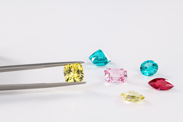 A close up of a gemstone collection with a magnifying glass