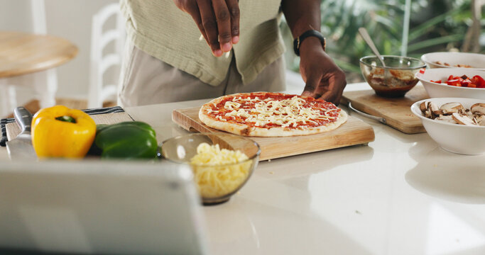 Hands, person and cooking pizza at house with meal prep, organic ingredients and healthy food. Chef, tablet and cheese toppings for Italian cuisine, vegetables and culinary skills for homemade lunch