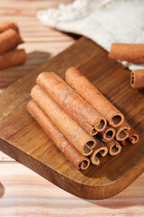Natural Cinnamon Sticks on Wooden Board - Aromatic Spice Seasoning for Cooking and Baking