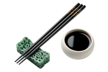 Black chopsticks with soy sauce and a green chopstick rest isolated on transparent background