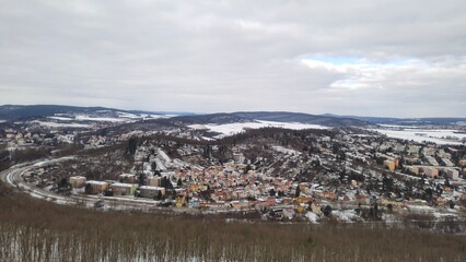 Charming panoramic view of a snow covered village surrounded by trees and fields near Brno, Czech Republic.