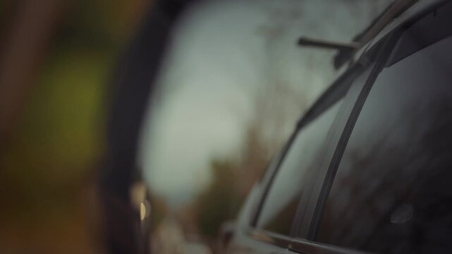 A blurred view of the car's rear view mirror.