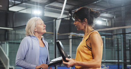 Padel, talking and fitness with friends on court for training, tournament club and challenge. Sports athlete, discussion and health with mature women on turf for competition, game and workout