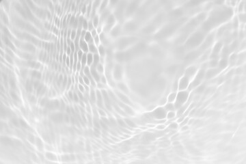 White water with ripples on the surface. Defocus blurred transparent white colored clear calm water surface texture with splashes and bubbles. Water waves with shining pattern texture background.