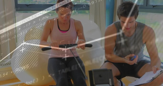 Rowing woman in pink tank and dark leggings on rowing machine at gym, trainer recording clipboard - Powered by Adobe