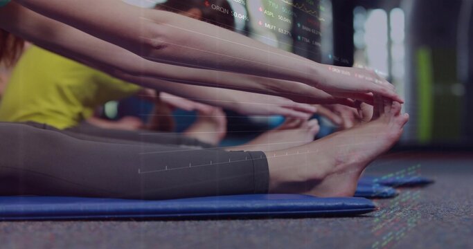 Stretching group performing forward bends at gym on blue mats with dark leggings, chart overlay
