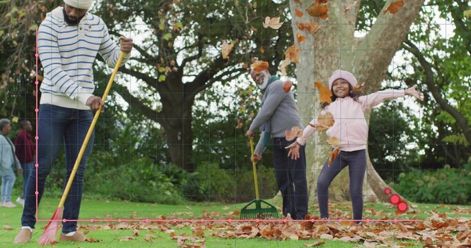 Raking multigenerational family using rakes on grassy park lawn, tossing leaves, wearing knit hats - Powered by Adobe